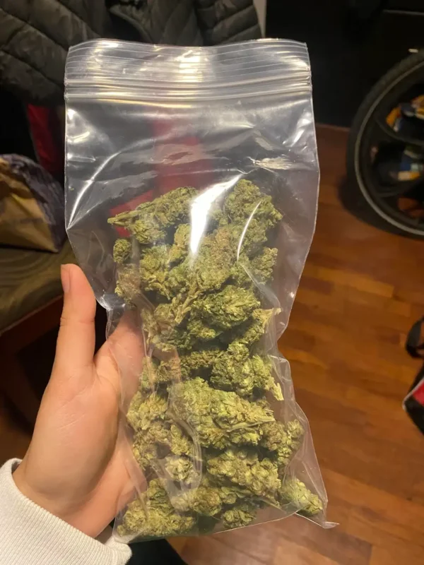 Review of a happy customer displaying his weed